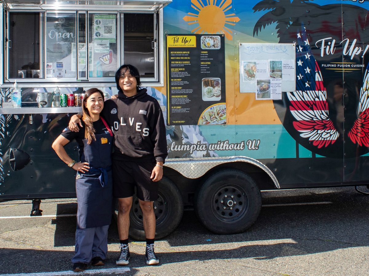 Chef Sarah and her son Sean standing arm in arm in front of the Fil Up! trailer on a sunny day